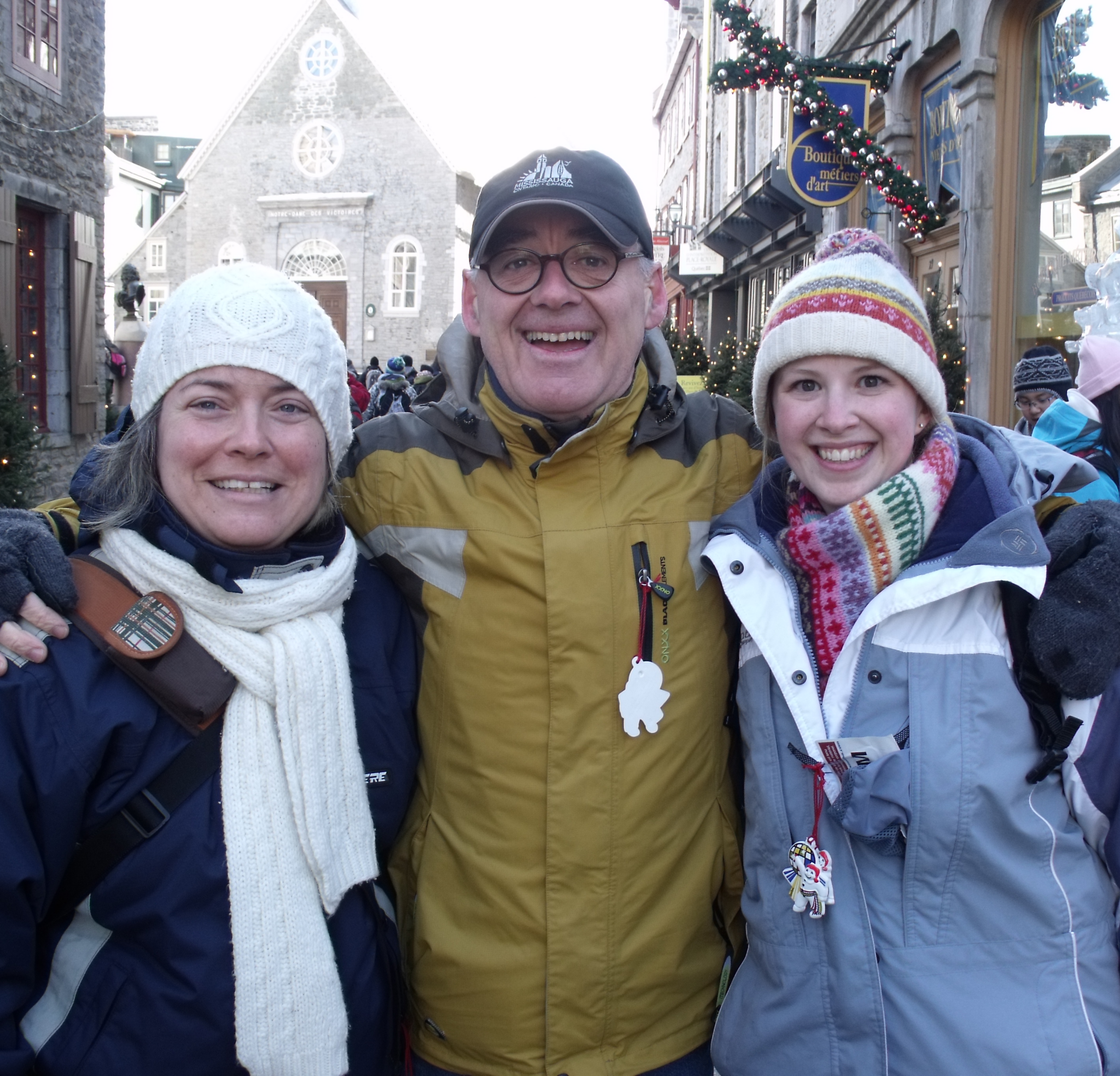 Daniel Bernier poses with two Group Organizers from past Experiences Canada exchanges on a festive winter street in Québec City.